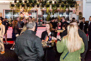 Company Rebranding Cocktail Evening Guests Mingling Wide Shot